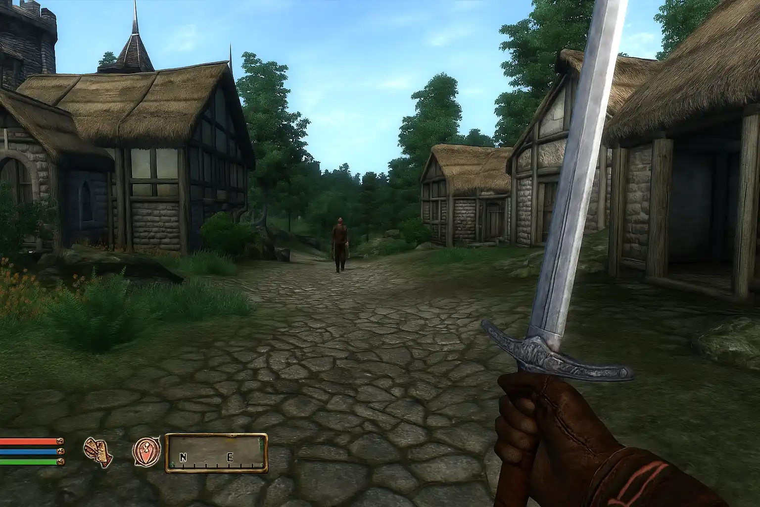 Capture d’écran d’Oblivion sur PS3 montrant une vue en première personne dans un village médiéval avec épée en main